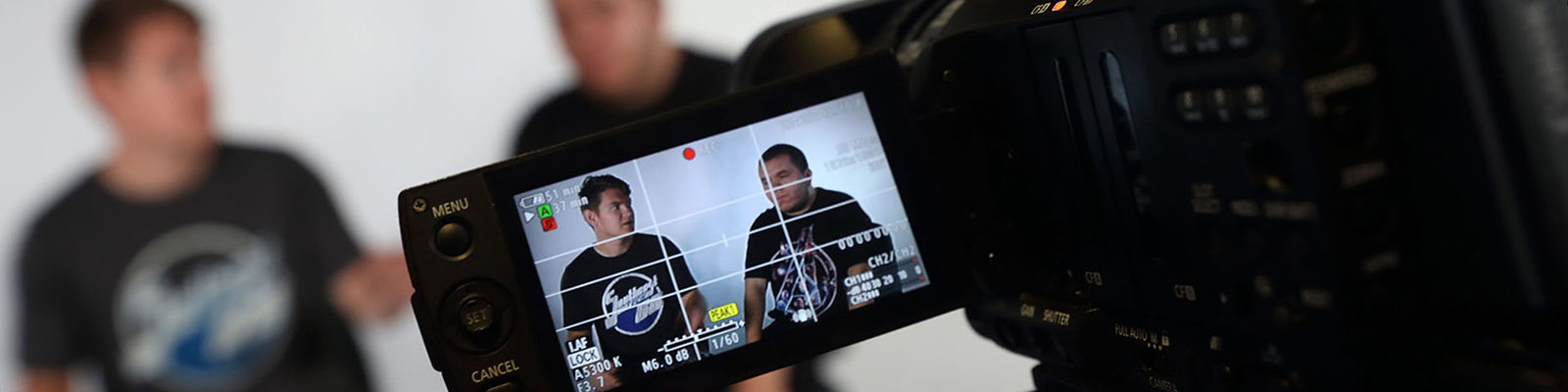 Two males being interviewed by person with video camera