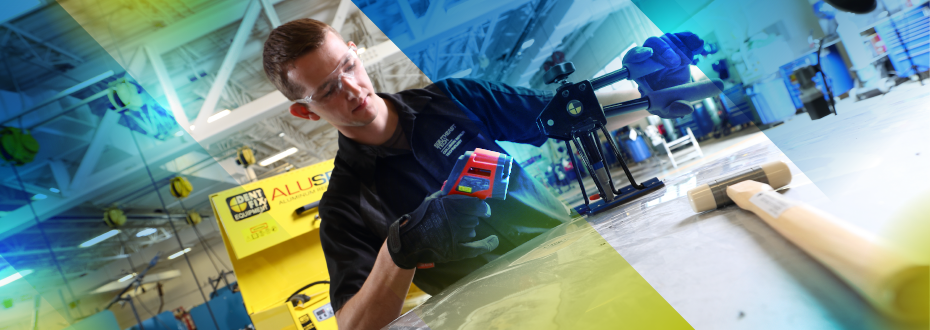 Instructor and student with laptop and auxiliary monitor reviewing CAD design