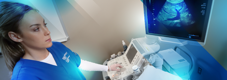 Student performing abdominal exam on patient with sonography machine, looking at screen