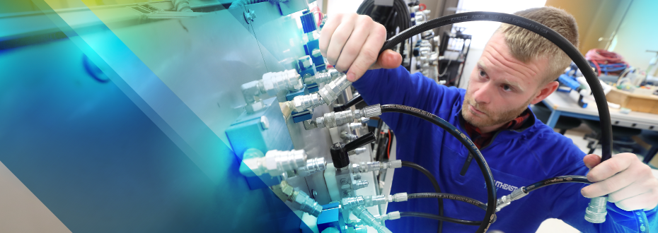 Mechatronics students working on large electronic and robotic project in a classroom