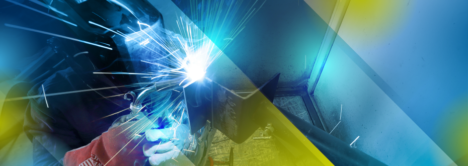 Side view of a Southeast Tech student in welding gloves and mask using a torch on a weld