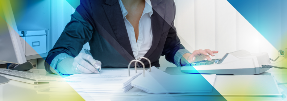 Young woman typing while on office phone