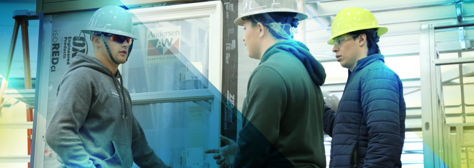 Students putting up walls for a house they are working on